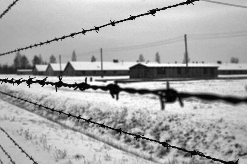 An exterior black and white photo of Auschwitz.