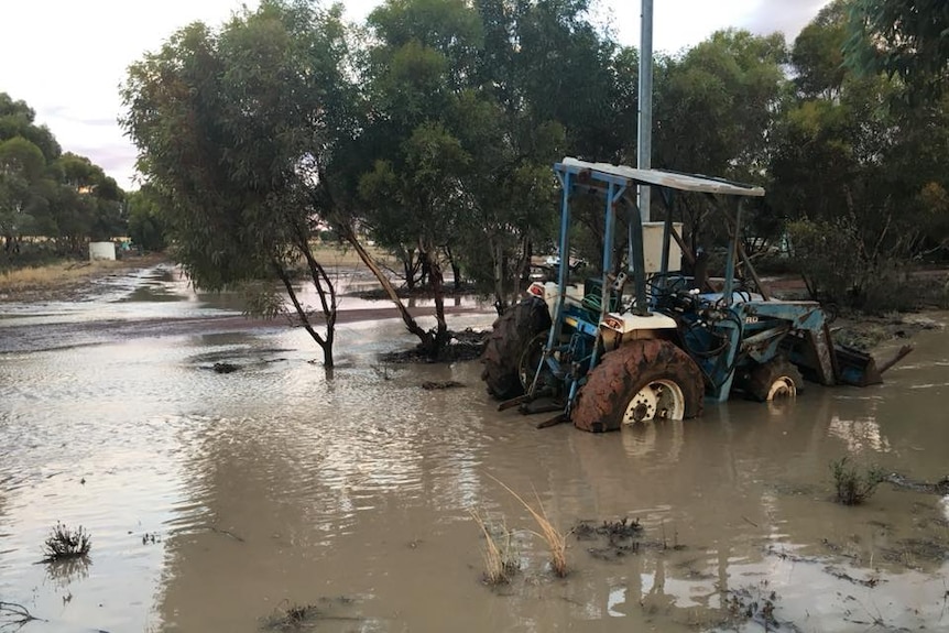 A tractor is submerged in water after a major deluge.