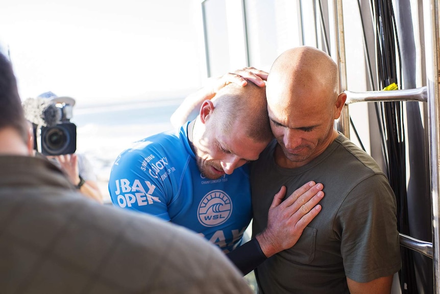 Mick Fanning embraced by Kelly Slater after shark attack