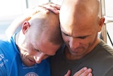 Mick Fanning embraced by Kelly Slater after shark attack