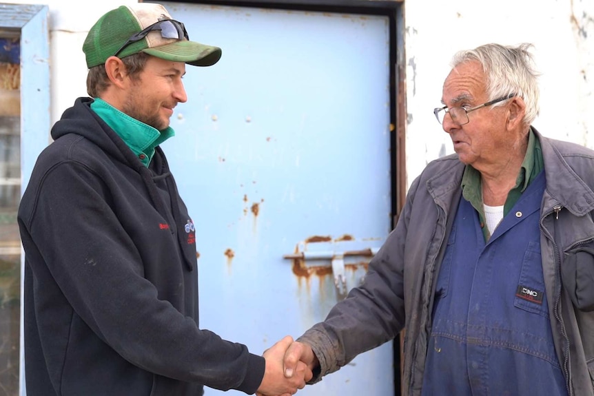 Mechanic Maurice Henry passes keys of his business to Justin Boyd