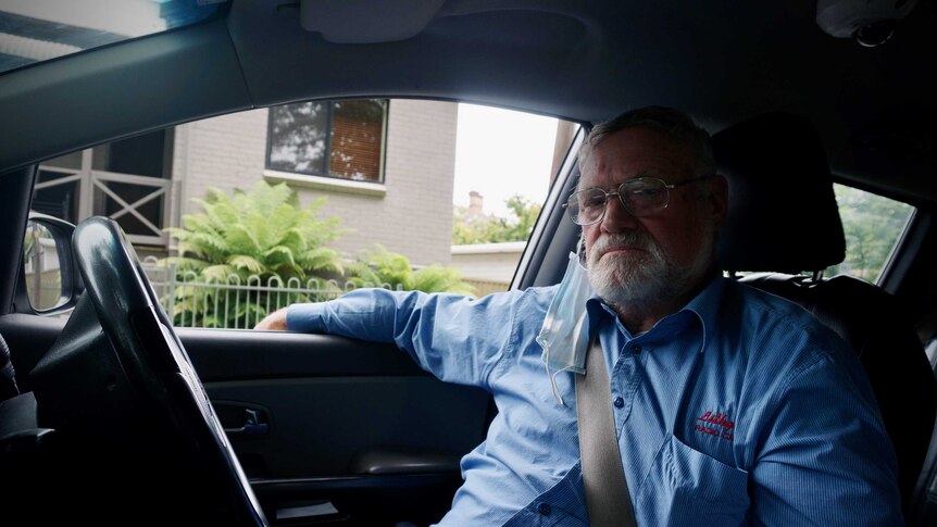 Ex-coal miner Jeffrey Smith sits in his taxi.