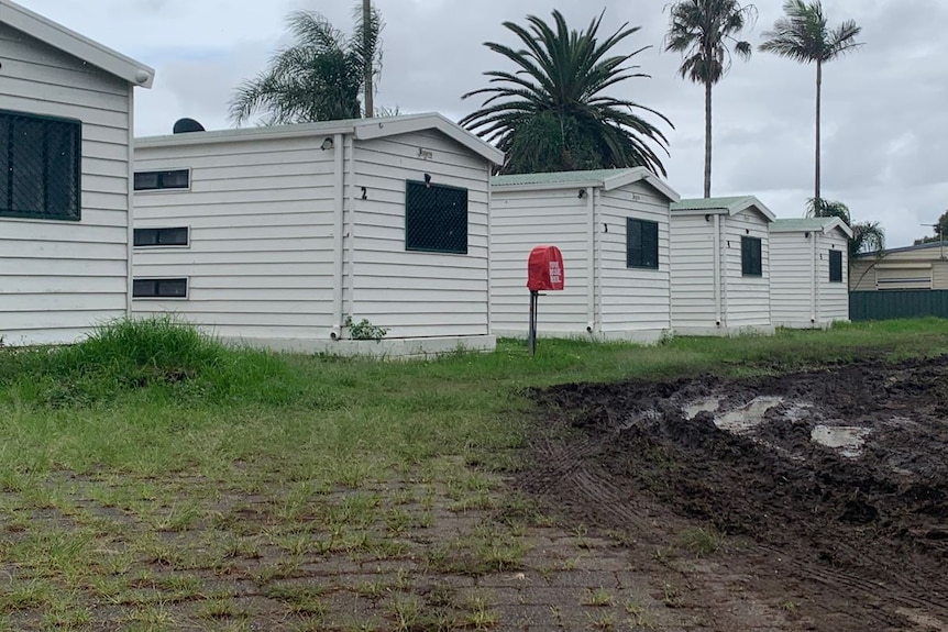 Muddy ground ripped up by tyres at a caravan park