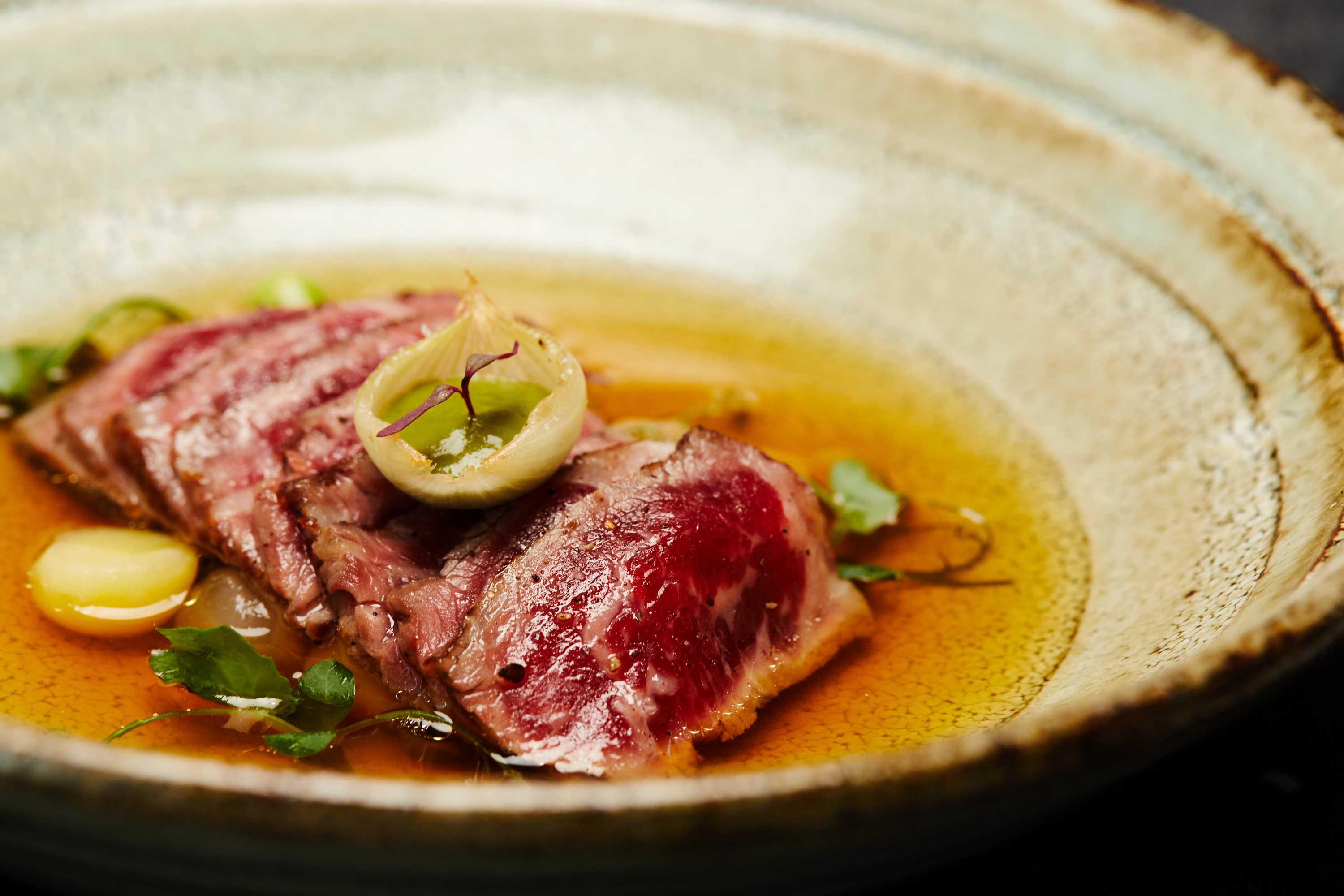a sliced steak in a bowl.