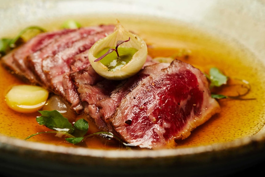 a sliced steak in a bowl.