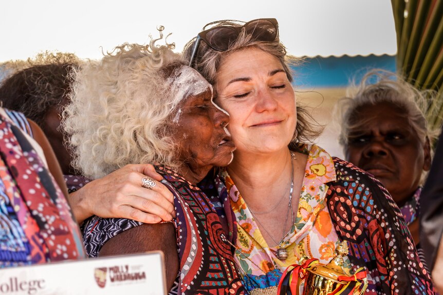 Elaine Guymun and Renee Adair embrace after the graduation ceremony for the doula program in East Arnhem Land.