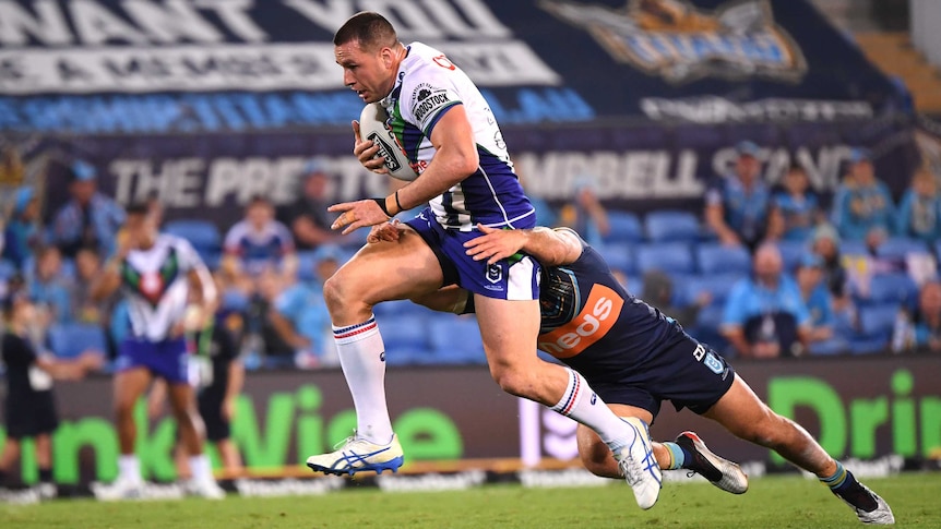 The Warriors' Lachlan Burr makes a bust against the Titans