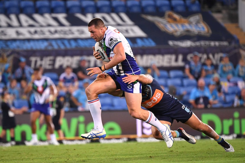 The Warriors' Lachlan Burr makes a bust against the Titans