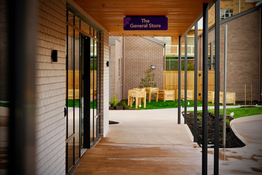 A sign for the general store outside a building in a dementia village