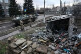 Ukrainian armed forces stand near a damaged building in Debaltseve, Donetsk region