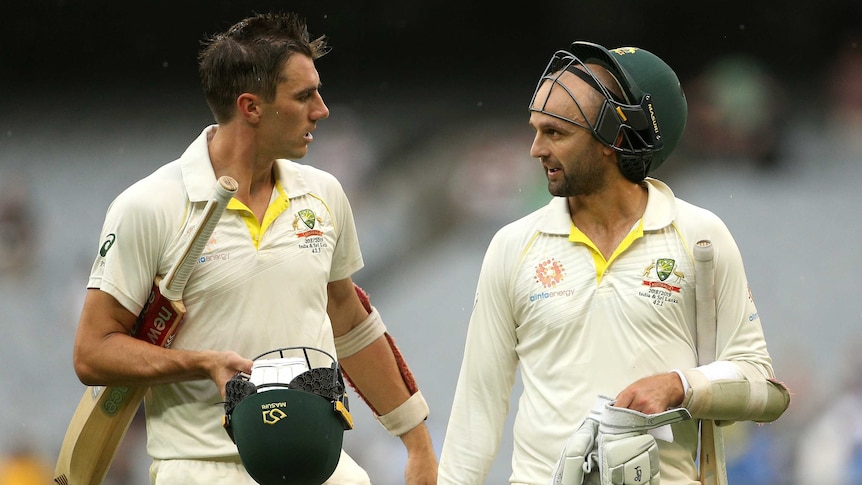 Australia's Pat Cummins (L) and Nathan Lyon walk off the MCG after day four of the Boxing Day Test.
