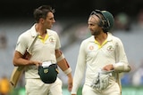 Australia's Pat Cummins (L) and Nathan Lyon walk off the MCG after day four of the Boxing Day Test.
