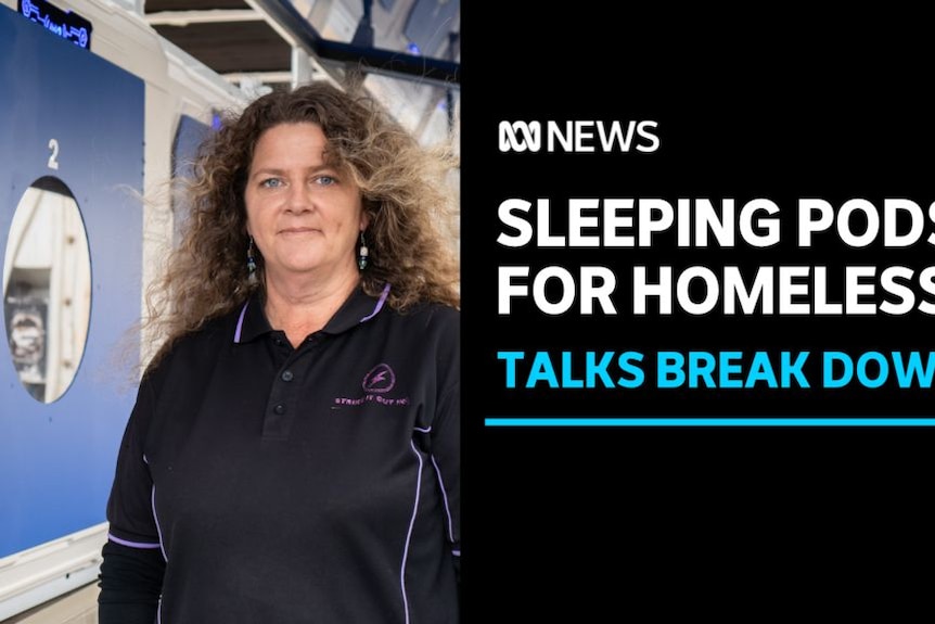 Sleeping Pods for Homeless, Talks Break Down: A woman stands in front of pod shelters.