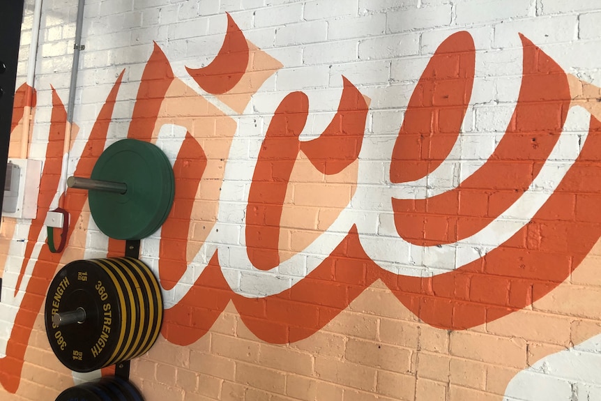 A wall mural says 'nice' as part of 'have a nice time'.