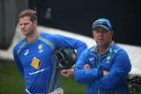 Australian captain Steve Smith (L) and coach Darren Lehmann look on during a net session in Hobart.