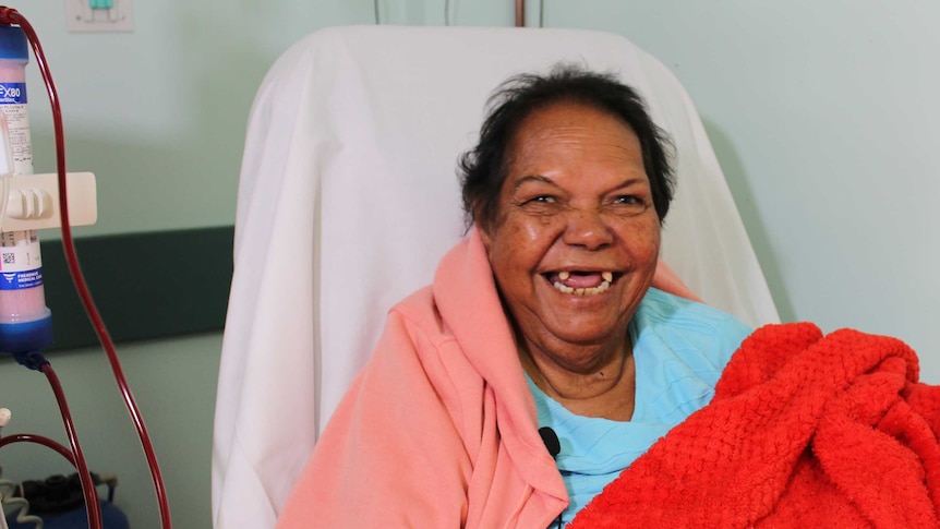 A woman in hospital, receiving dialysis treatment