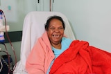 A woman in hospital, receiving dialysis treatment