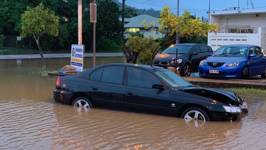 A damaged car sits in floodwaters at Railway Estate at Townsville.