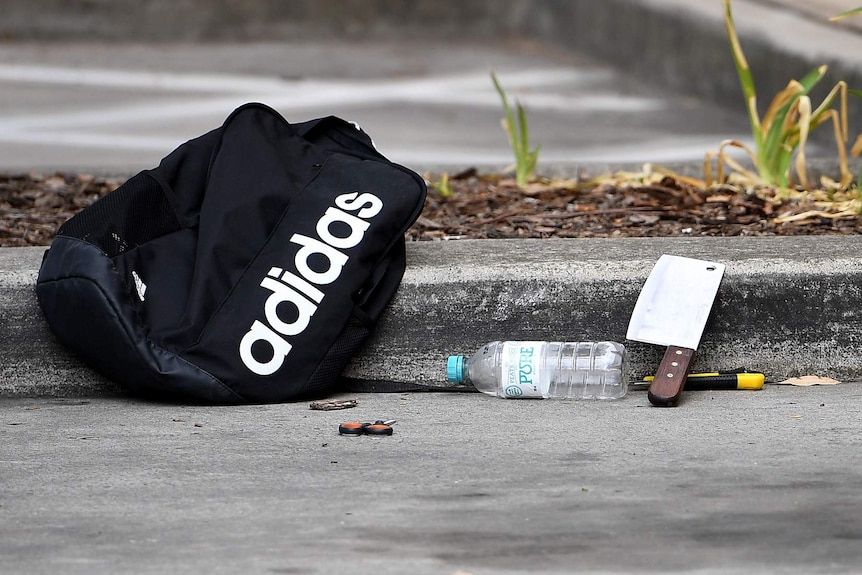 A backpack and knives along with scissors are seen at a shopping centre adjacent to Bonnyrigg high school, west of Sydney