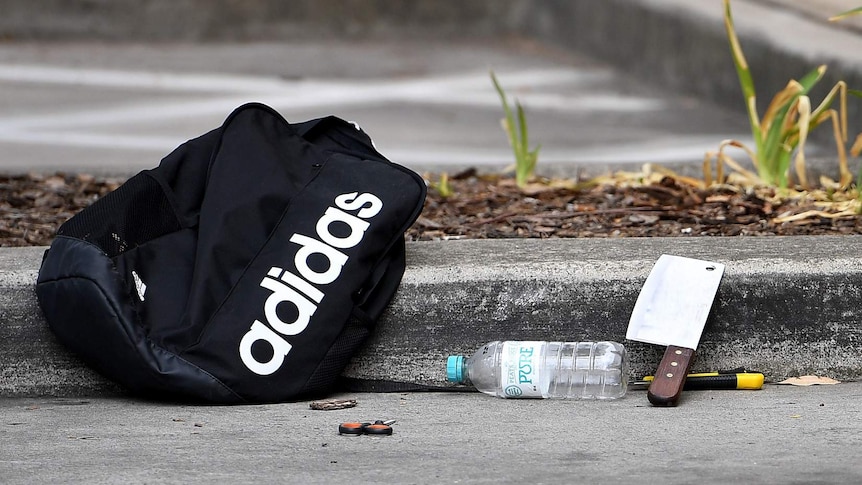 A backpack and knives along with scissors are seen at a shopping centre adjacent to Bonnyrigg high school, west of Sydney