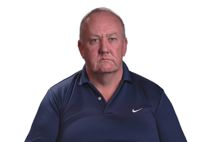 Headshot of a man wearing a blue Nike polo shirt set against white background
