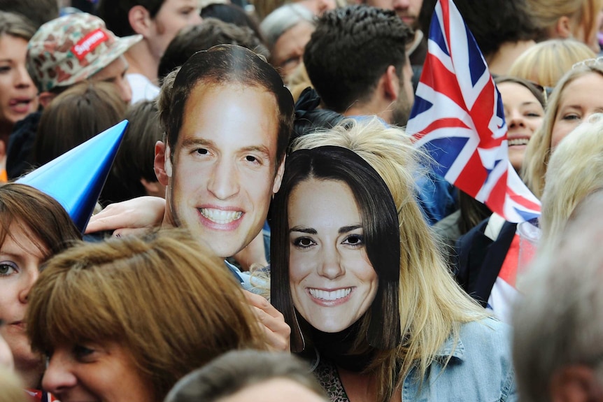 Royal fans wear masks of Will and Kate's faces.