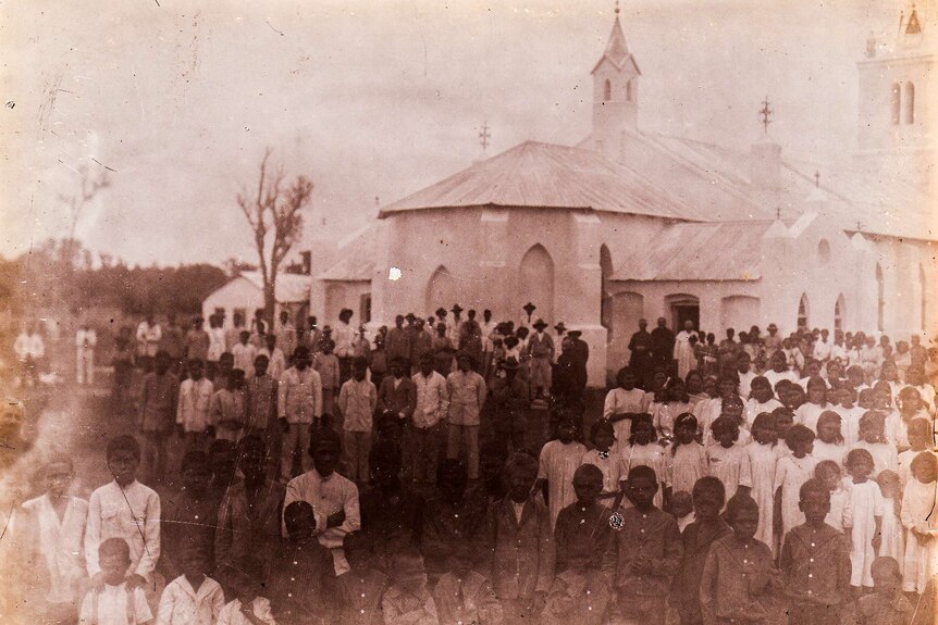 The Beagle Bay church surrounded by people.