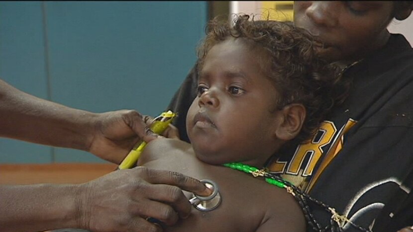 Doctor checks Aboriginal boy with stethoscope.