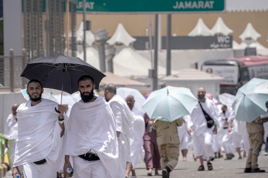 Muslim pilgrims walk along at the Mina tent camp in Mecca