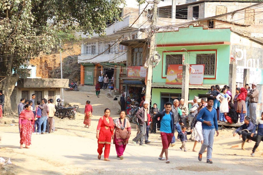 People walking in a village in Nepal.