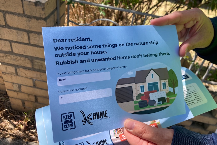 A cardboard flyer to residents saying "we noticed some things on your nature strip" and saying council be back to see them.