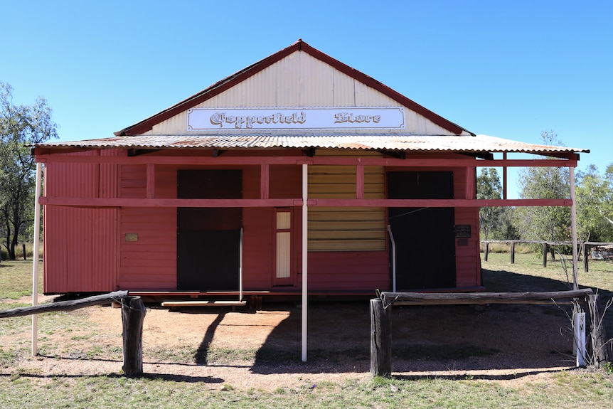 A weatherboard and tin shop from the 1800s, with the sign Copperfield Store, boarded up near Clermont QLD.