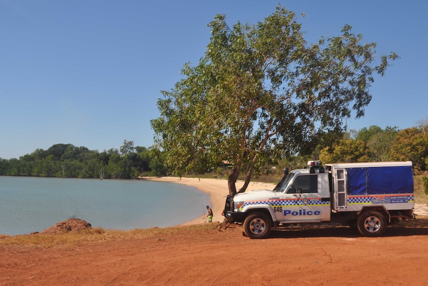 A police car parked next to the Maningrida barge ramp.