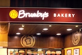 Shoppers walk past a Brumby's Bakery in Melbourne