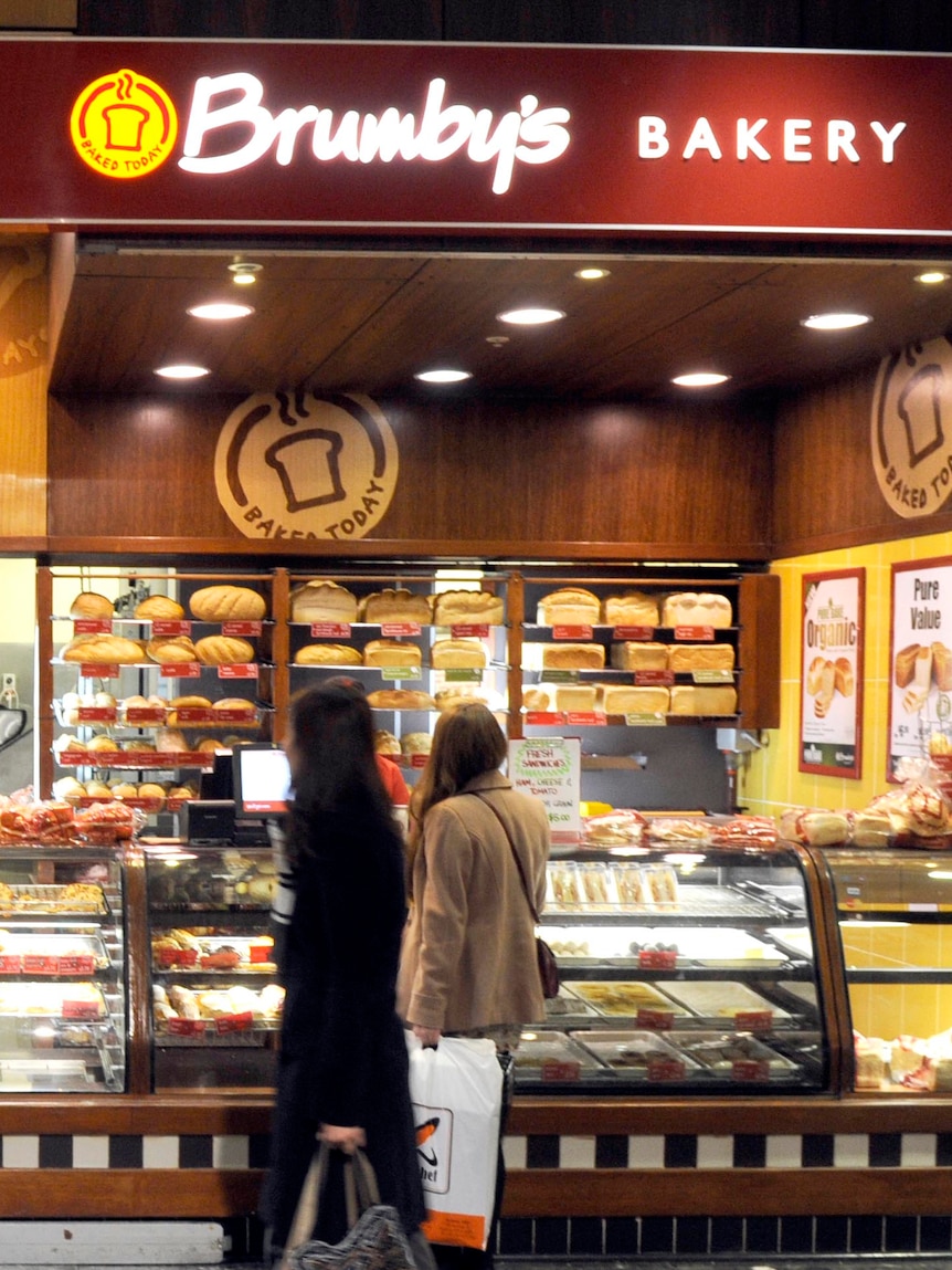 Shoppers walk past a Brumby's Bakery in Melbourne