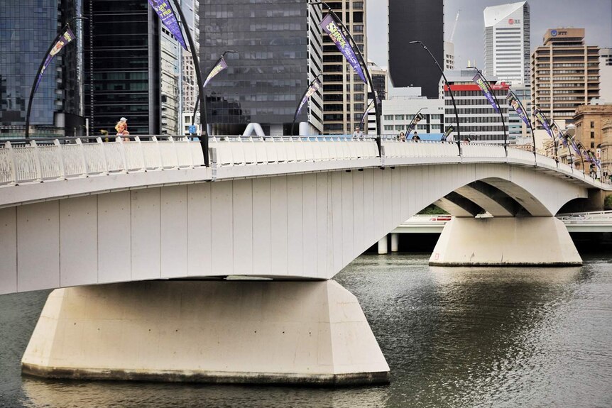Pedestrians walk over Victoria Bridge in Brisbane's city on January 21, 2021.