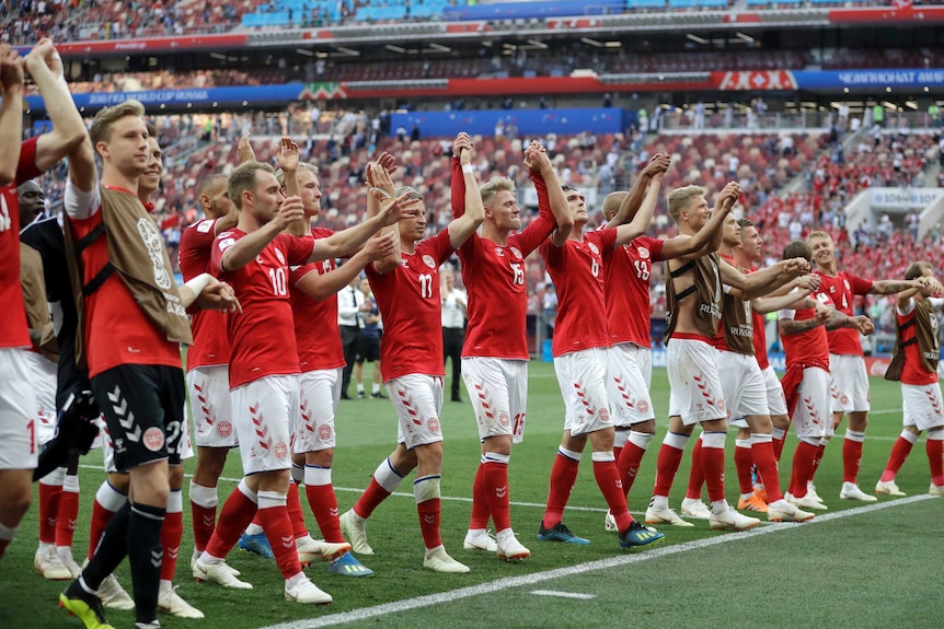 Denmark players celebrate progression to round of 16