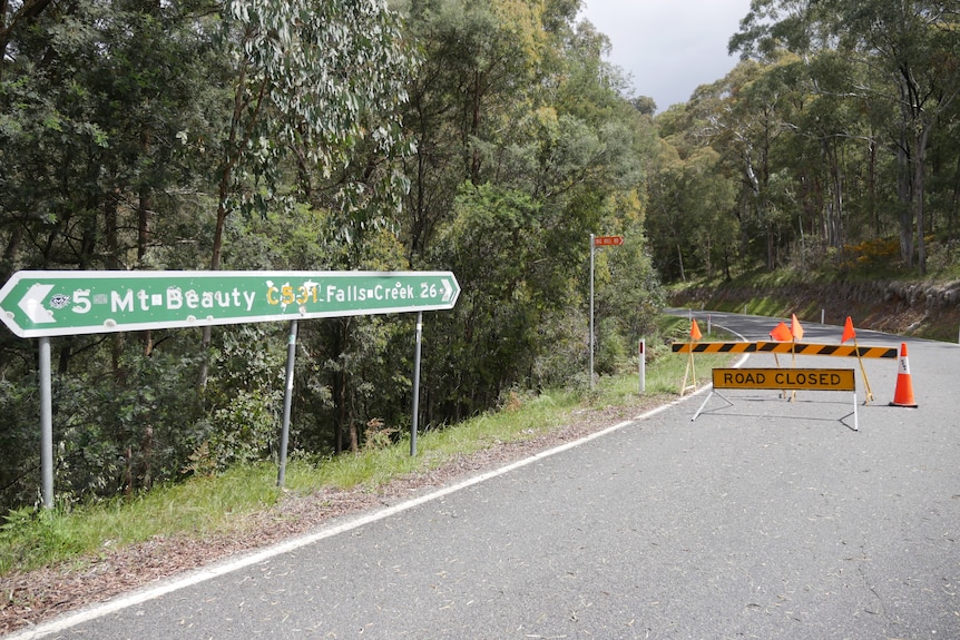 Road sign Mount Beauty to Falls Creek, and road closure sign.