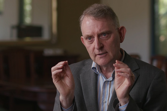 Finance data analyst Martin North gestures with his hands as he speaks to Four Corners.