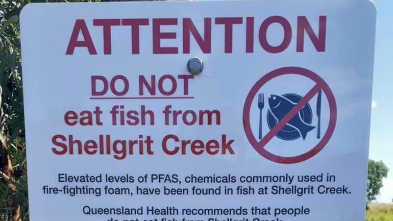 A sign reading ATTENTION DO NOT eat fish from Shellgrit Creek the bottom of the sign includes a map of PFAS contaminated areas