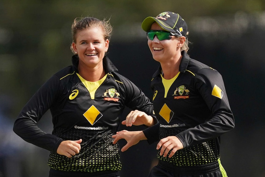 Australia bowler Jess Jonassen (left) and captain Meg Lanning smile in the field during a Twenty20 cricket match against India.