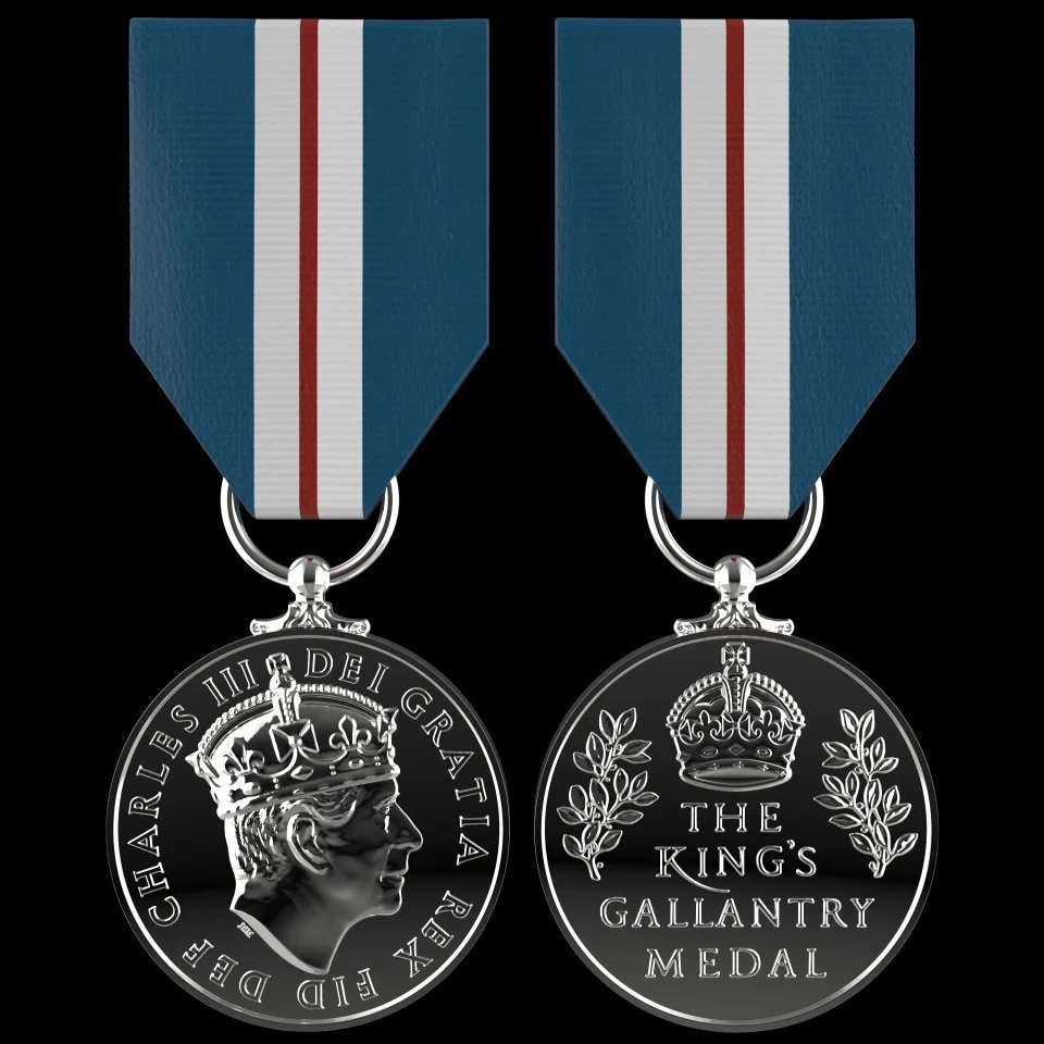 The back and front of the King's Gallantry Medal. It is silver and has on one side his face and the other the name of the medal