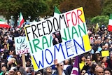 A large group of people protesting in Australia. Main sign says 'Freedom for Iranian Women'.