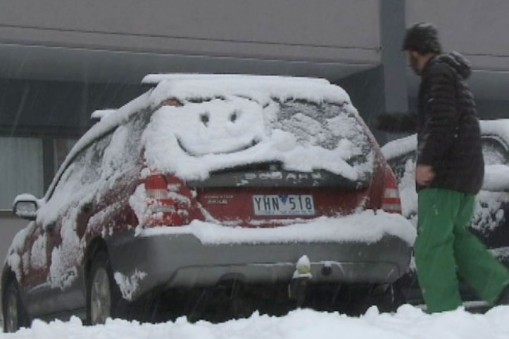 Smiley face in the snow on the back of a car at Falls Creek
