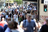 Shoppers walk through Queen Street Mall in Brisbane