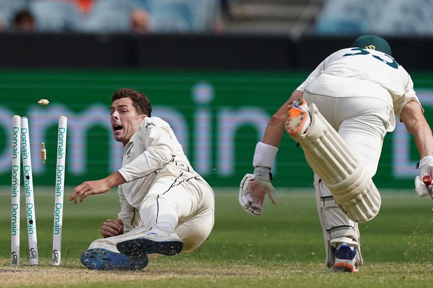 Santner grimaces as he breaks the wickets to run out Marnus Labuschagne, charging in to make his ground