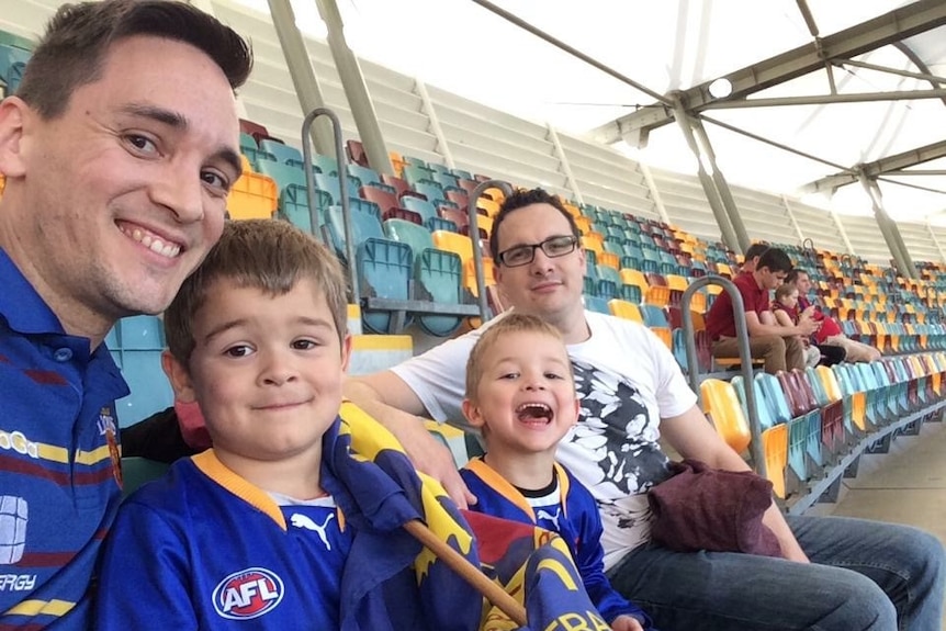 Michael Knowels and Jared Merrel, Elijah Merrel-Knowels, and Huxley Merrel-Knowels at a football match.