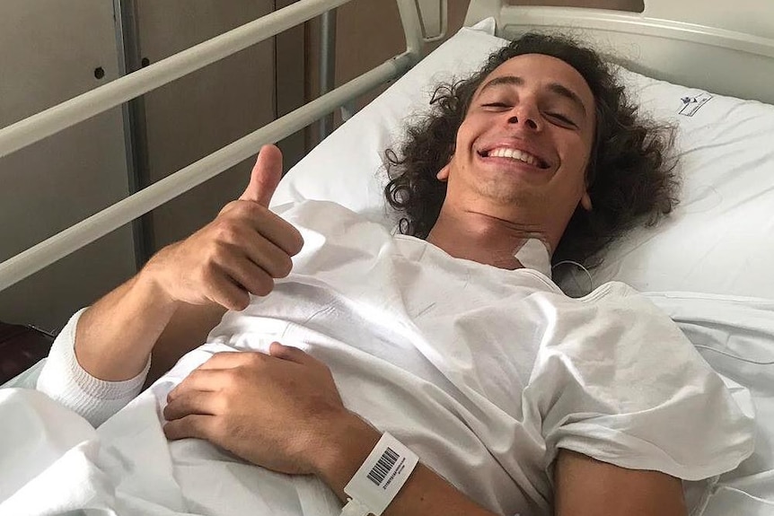 Tasmanian race driver Alex Peroni in hospital bed.