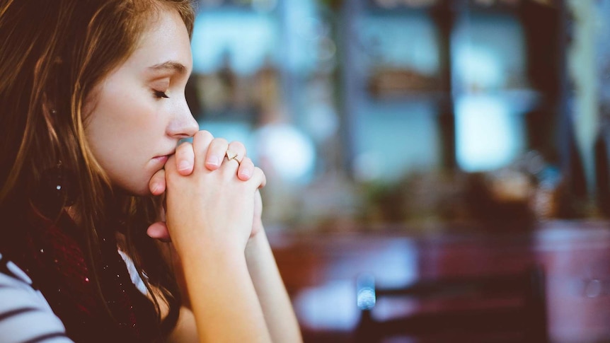 Woman in contemplation for a story about how not to respond to criticism in a defensive way