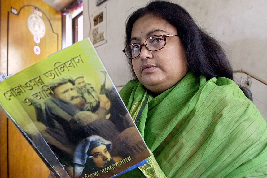 Sushmita Banerjee holds one of her Bengali language novels.